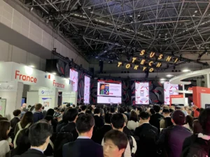 The SusHi Tech Tokyo 2026 exhibition hall with the Pavillon France and a large crowd