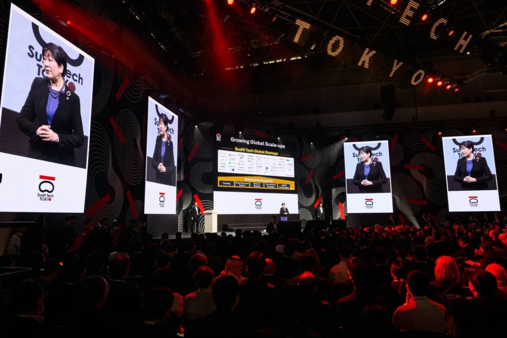Main stage session with large screens and a full audience at SusHi Tech Tokyo 2026